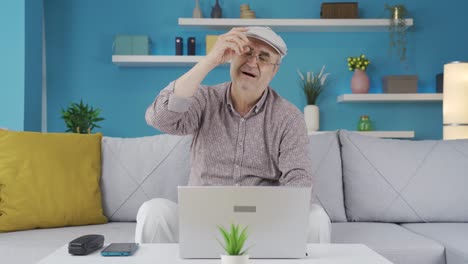 Elderly-man-using-laptop-has-a-sore-neck.